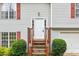 Inviting front entrance featuring a classic white door, small porch, and well-maintained landscaping at 5519 Princeton Oaks Ln, Sugar Hill, GA 30518