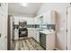Modern kitchen with stainless steel appliances, white cabinets, and a stylish backsplash at 5519 Princeton Oaks Ln, Sugar Hill, GA 30518