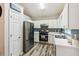 Bright kitchen featuring stainless steel appliances, updated fixtures, and ample counter space at 5519 Princeton Oaks Ln, Sugar Hill, GA 30518