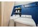 Laundry room with a side-by-side washer and dryer and built-in shelving at 5519 Princeton Oaks Ln, Sugar Hill, GA 30518