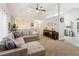 Open-concept living room with vaulted ceiling, neutral tones, and seamless flow to the adjacent kitchen at 5519 Princeton Oaks Ln, Sugar Hill, GA 30518