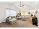 Spacious living room features vaulted ceilings, a ceiling fan, and a comfortable sectional sofa at 5519 Princeton Oaks Ln, Sugar Hill, GA 30518
