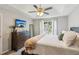 Bright main bedroom with a large window offering an outside view and relaxing decor at 5519 Princeton Oaks Ln, Sugar Hill, GA 30518