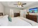Spacious main bedroom with a trey ceiling, ceiling fan, closet and ensuite bathroom at 5519 Princeton Oaks Ln, Sugar Hill, GA 30518