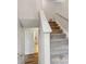 Carpeted staircase with white railing leading to the upper level, adjacent to a modern interior at 5519 Princeton Oaks Ln, Sugar Hill, GA 30518