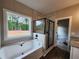 Bathroom with soaking tub, glass shower, granite vanity, and bright window at 92 Jeffrey Ln, Dallas, GA 30157