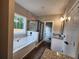 Bathroom with soaking tub, glass shower, granite vanity, and great natural light at 92 Jeffrey Ln, Dallas, GA 30157