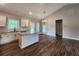 Stylish kitchen with island, white cabinets, and stainless steel appliances overlooking living space at 92 Jeffrey Ln, Dallas, GA 30157