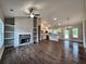 Bright living room with fireplace and built-in shelves open to kitchen with island at 92 Jeffrey Ln, Dallas, GA 30157