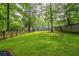 Spacious backyard featuring mature trees and a privacy fence at 176 Olympic Pl, Decatur, GA 30030