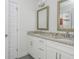 Bright bathroom featuring granite countertops, double sinks, and modern fixtures at 176 Olympic Pl, Decatur, GA 30030