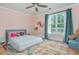 Cozy bedroom with a colorful rug, natural light, and ceiling fan at 176 Olympic Pl, Decatur, GA 30030