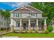 Charming two-story home featuring a welcoming front porch with stone pillars and landscaped yard at 176 Olympic Pl, Decatur, GA 30030