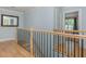 Upstairs hallway featuring hardwood floors and a view of the staircase at 176 Olympic Pl, Decatur, GA 30030