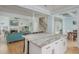 Open floor plan showcases the kitchen island with a marble countertop, adjacent to the living room at 176 Olympic Pl, Decatur, GA 30030