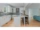 Bright kitchen features white cabinets, stainless steel appliances, and a large island with seating at 176 Olympic Pl, Decatur, GA 30030