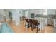Expansive open-concept living space with eat-in kitchen, seating at the island, and access to the staircase at 176 Olympic Pl, Decatur, GA 30030