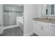Elegant main bathroom with a walk-in glass shower and vanity with stone countertop at 176 Olympic Pl, Decatur, GA 30030