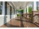 Inviting front porch with stone pillars, ceiling fans, and a wooden floor, perfect for relaxing outdoors at 176 Olympic Pl, Decatur, GA 30030