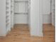 Spacious walk-in closet featuring custom shelving and hardwood floors at 176 Olympic Pl, Decatur, GA 30030