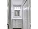This updated bathroom features a single sink vanity with marble countertop, and a large mirror at 2135 N Forest Trl, Dunwoody, GA 30338