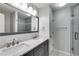 Bathroom features a double sink vanity with marble countertop and tiled shower at 2135 N Forest Trl, Dunwoody, GA 30338