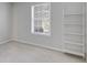 This light and airy bedroom features a bright window and a white bookshelf at 2135 N Forest Trl, Dunwoody, GA 30338