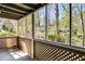Cozy screened porch featuring latticework and providing ample shade with peaceful views of the surrounding landscape at 2135 N Forest Trl, Dunwoody, GA 30338
