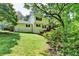 Exterior view of the home with a big backyard and shade trees at 10035 Anaheim Dr, Alpharetta, GA 30022