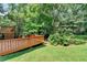 Expansive backyard with a deck and a mature tree line providing ample shade at 10035 Anaheim Dr, Alpharetta, GA 30022