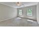 Well-lit bedroom featuring dual windows and neutral carpet at 10035 Anaheim Dr, Alpharetta, GA 30022