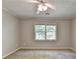 Bright bedroom featuring a large window and plush carpet at 10035 Anaheim Dr, Alpharetta, GA 30022