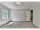Bedroom featuring neutral walls, carpet, and a ceiling fan, illuminated by natural light from the window at 10035 Anaheim Dr, Alpharetta, GA 30022