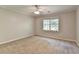 Bright bedroom featuring a large window and plush carpet at 10035 Anaheim Dr, Alpharetta, GA 30022