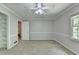 Bright bedroom featuring neutral walls, carpet, a ceiling fan, and closet space at 10035 Anaheim Dr, Alpharetta, GA 30022