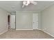 Spacious bedroom with neutral walls, plush carpet, ceiling fan, and two closets at 10035 Anaheim Dr, Alpharetta, GA 30022