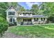 Charming two-story home with a well-manicured lawn and mature trees offering curb appeal at 10035 Anaheim Dr, Alpharetta, GA 30022