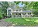 Charming two-story home with a well-manicured lawn and mature trees offering curb appeal at 10035 Anaheim Dr, Alpharetta, GA 30022