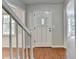 Welcoming foyer featuring hardwood floors, staircase, and a view of the front bay window at 10035 Anaheim Dr, Alpharetta, GA 30022