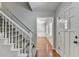 Welcoming foyer featuring hardwood floors, staircase, and a view of the front bay window at 10035 Anaheim Dr, Alpharetta, GA 30022