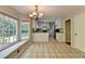 Charming kitchen with white cabinets, tiled floors, and a picturesque window view at 10035 Anaheim Dr, Alpharetta, GA 30022