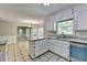 Bright eat-in kitchen featuring white cabinets, granite countertops, and tiled floors provides ample cooking space at 10035 Anaheim Dr, Alpharetta, GA 30022