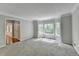 Spacious living room featuring plush carpeting, large windows, and elegant crown molding at 10035 Anaheim Dr, Alpharetta, GA 30022