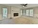 Bright living room featuring a stone fireplace, neutral decor, and access to the back deck at 10035 Anaheim Dr, Alpharetta, GA 30022