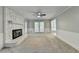 Bright living room features a stone fireplace, neutral decor, and access to the back yard at 10035 Anaheim Dr, Alpharetta, GA 30022