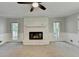 Bright living room featuring a stone fireplace and neutral decor at 10035 Anaheim Dr, Alpharetta, GA 30022