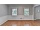 Living room boasts hardwood floors, neutral walls, and large windows at 10035 Anaheim Dr, Alpharetta, GA 30022