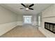 Spacious living room featuring neutral walls, plush carpeting, and a view to the home's sitting room at 10035 Anaheim Dr, Alpharetta, GA 30022