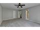 Main bedroom with gray carpet, neutral walls, and a ceiling fan at 10035 Anaheim Dr, Alpharetta, GA 30022