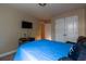 A comfortable bedroom featuring a bed, TV, and double door closet at 12275 Styron Dr, Hampton, GA 30228
